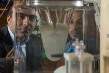 Ali Azadani and fellow researcher viewing a biomedical device in Azadani's lab