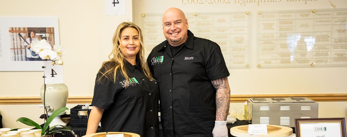 two chefs behind their table at event